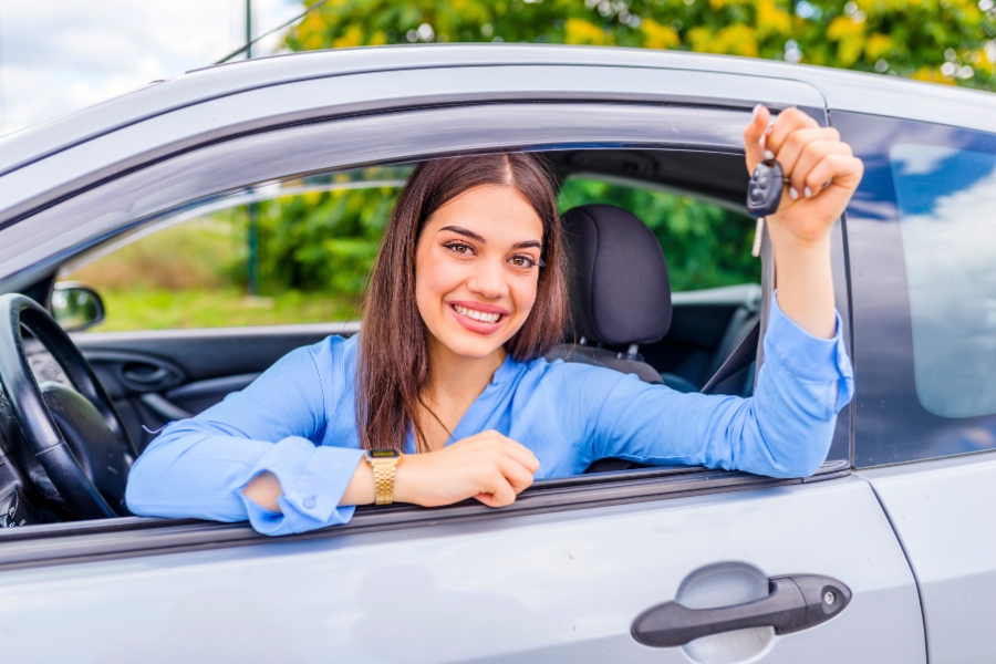 Woman Driving a Silver Car