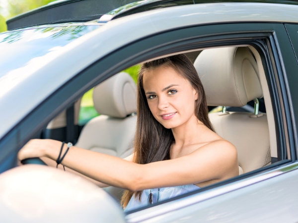 Woman Driving a Silver Car